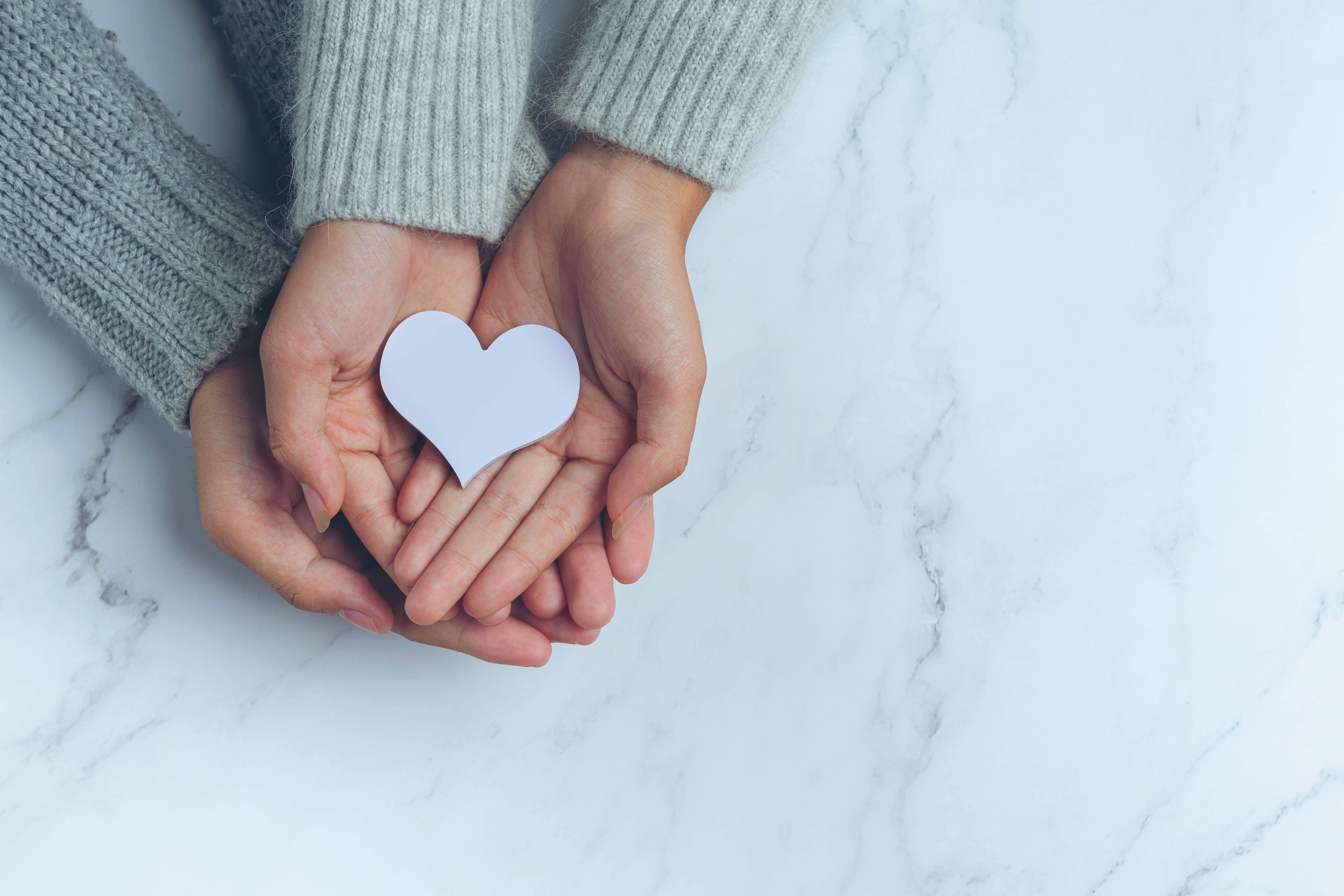 paper-heart-put-couple-s-hands-marble-table.jpg