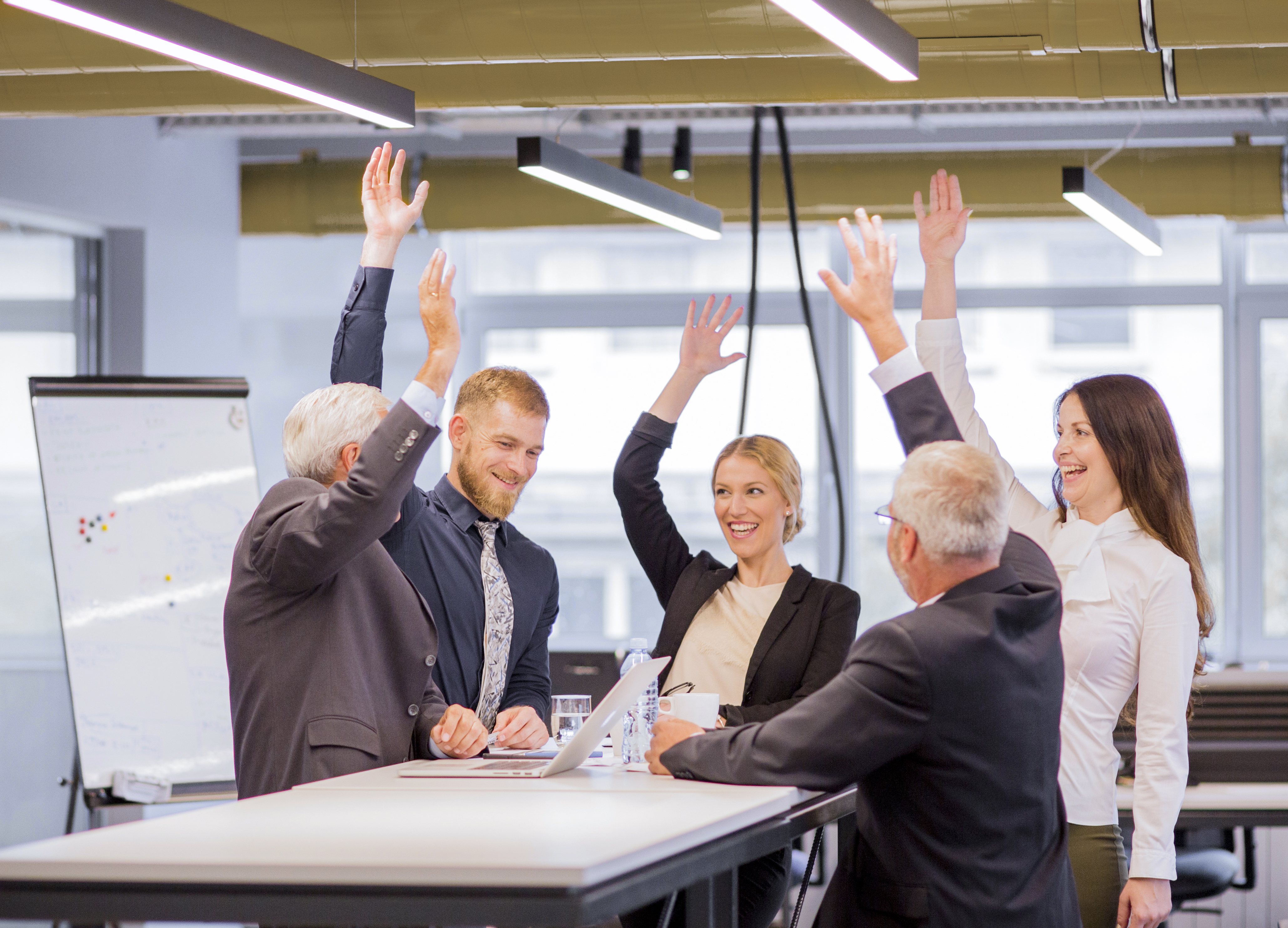 cheerful-business-people-in-the-meeting-raising-the-arms.jpg