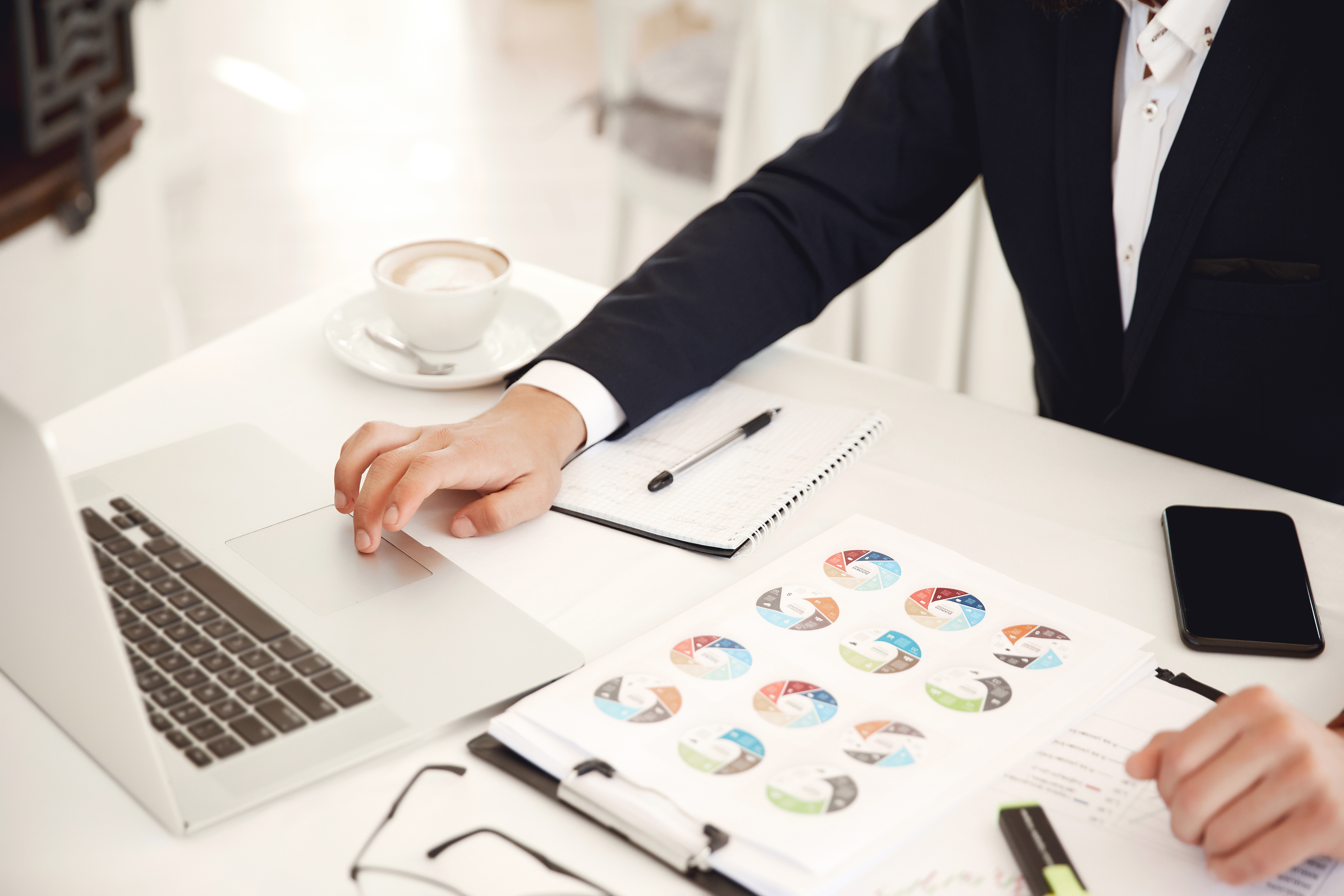 cropped-frontview-businessman-working-place-restaurant-with-laptop-cellphone-diagrams-latte.jpg