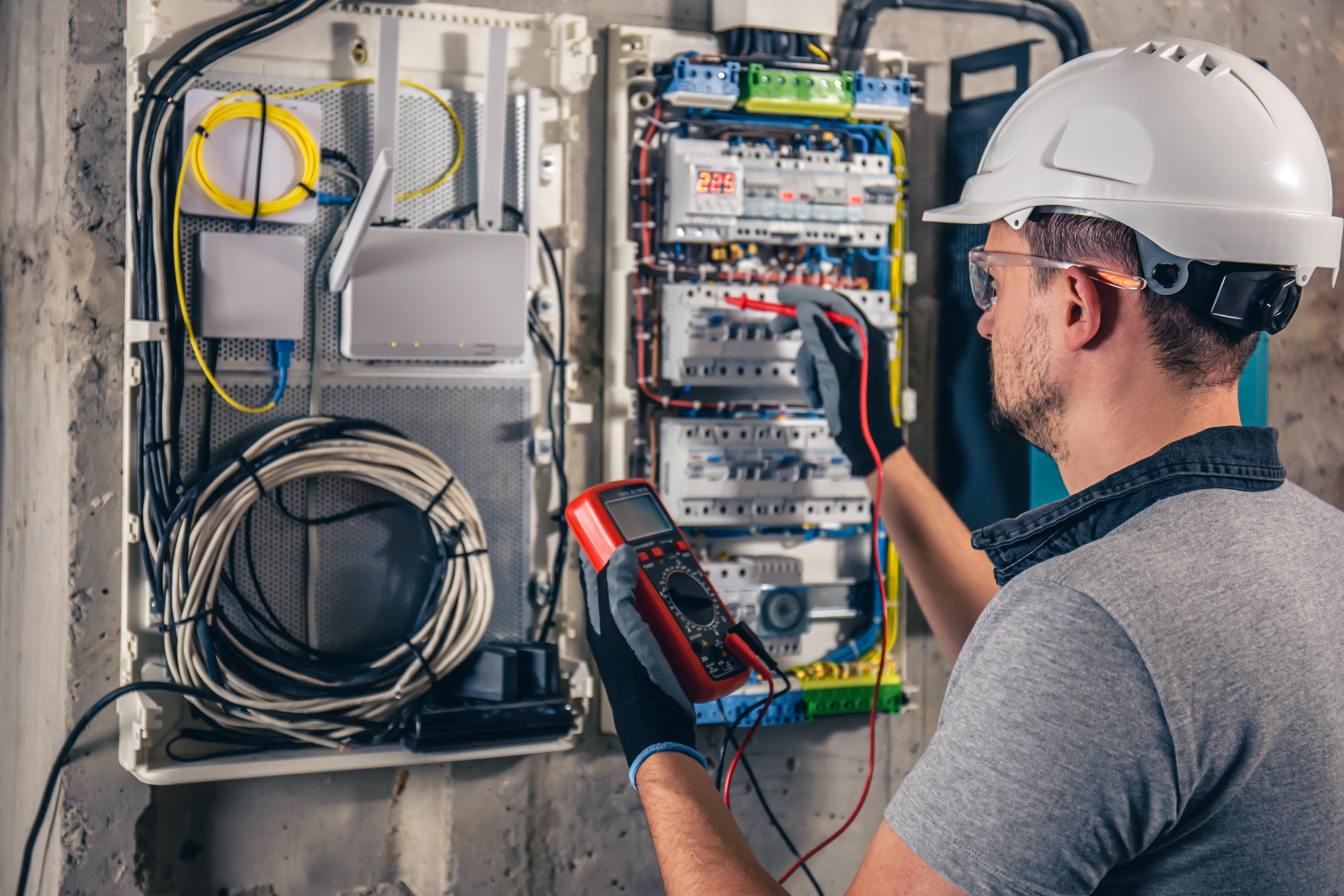 man-electrical-technician-working-switchboard-with-fuses.jpg man-electrical-technician-working-switchboard-with-fuses.jpg