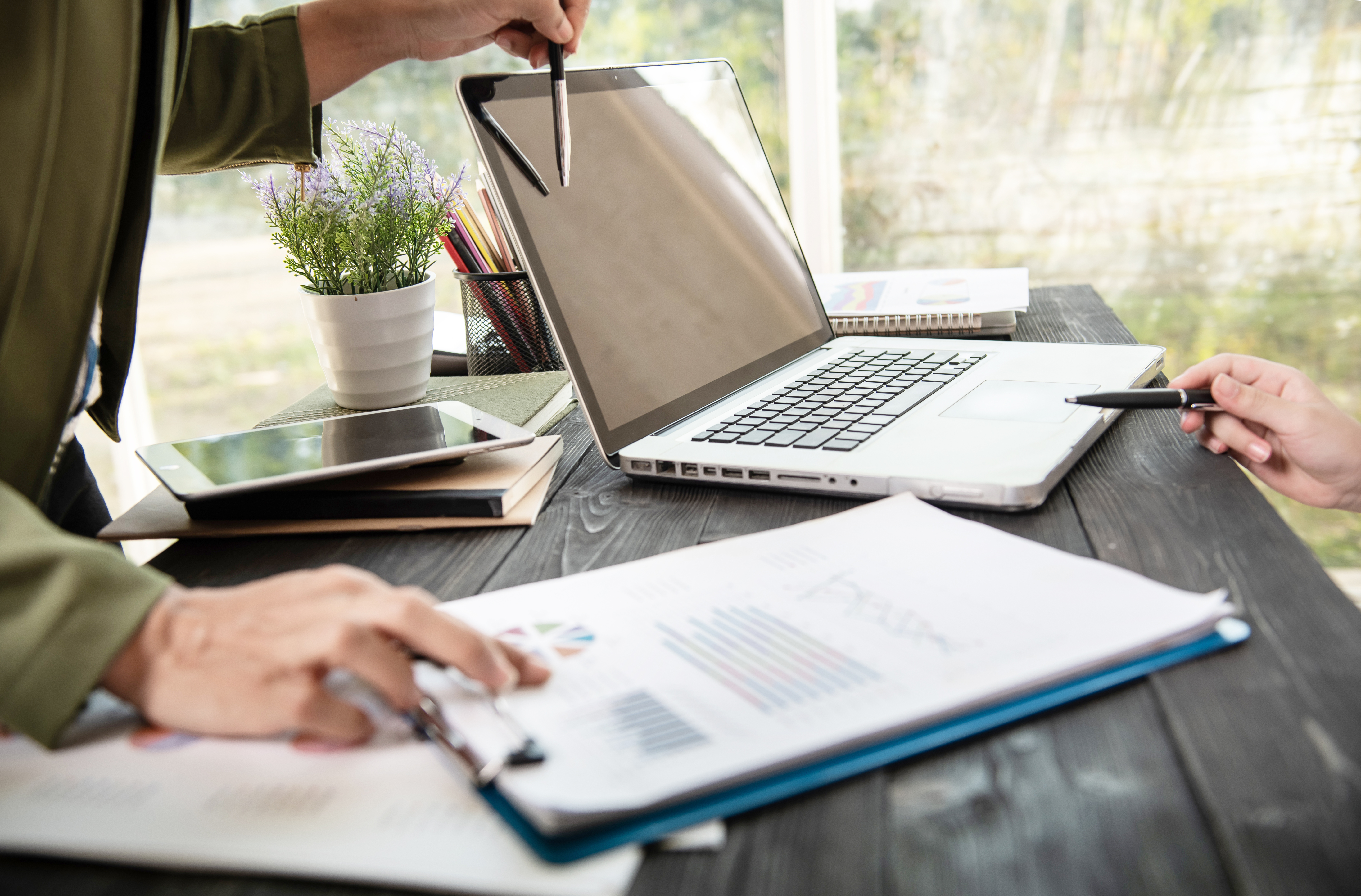 business-woman-hands-using-laptop-computer-placed-messy-office-desktop.jpg