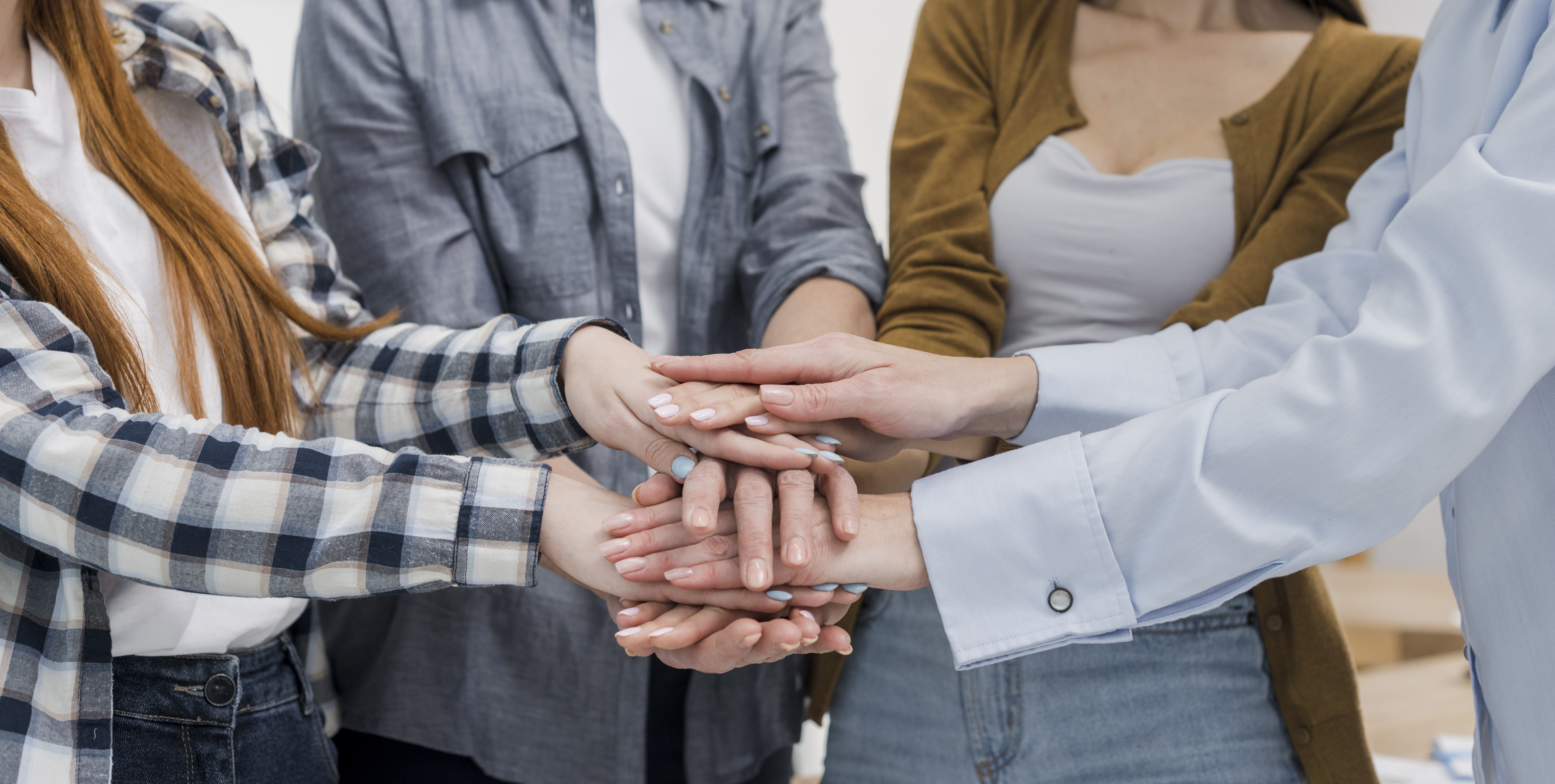 group-female-friends-touching-hands.jpg