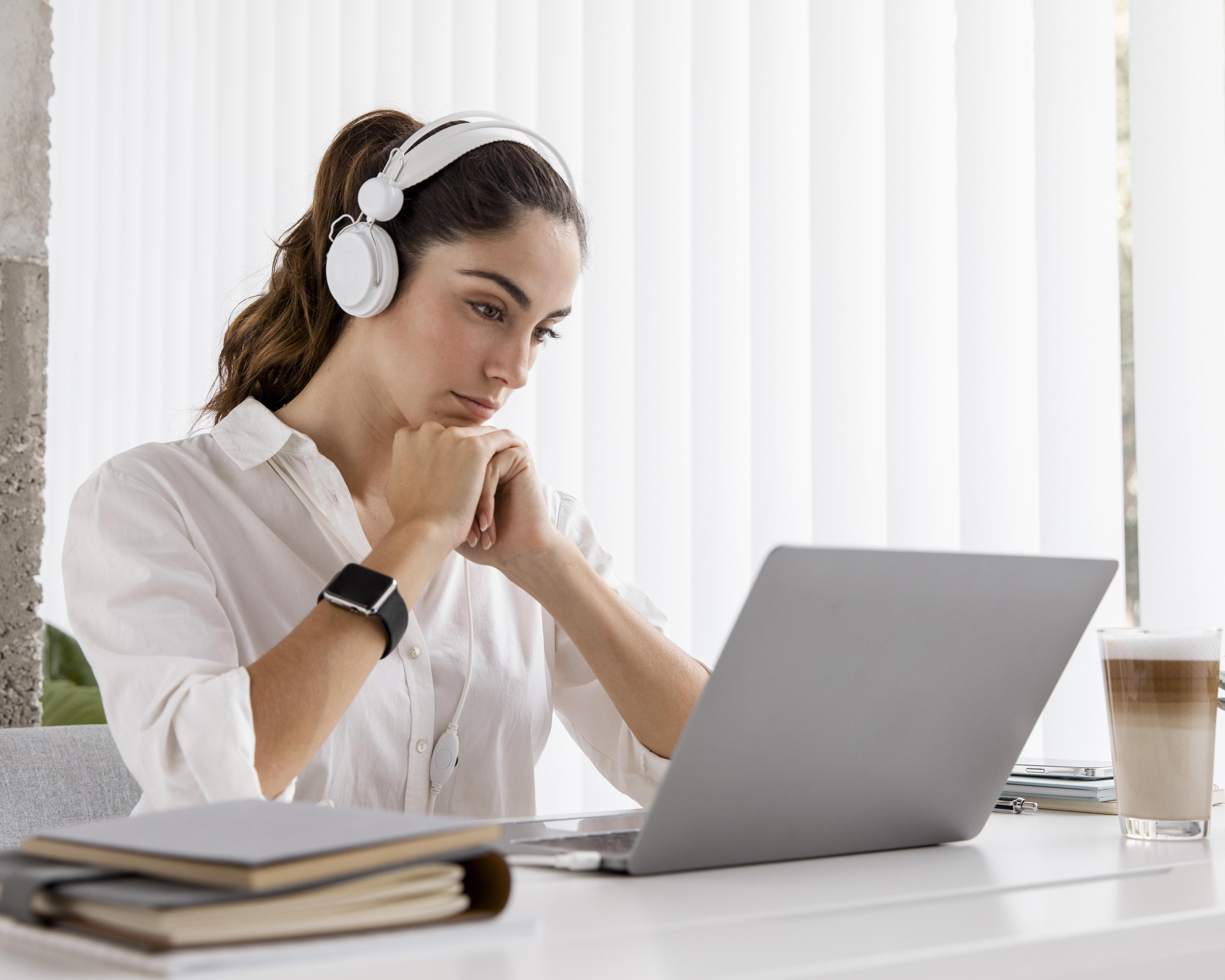 side-view-businesswoman-working-with-laptop-headphones.jpg