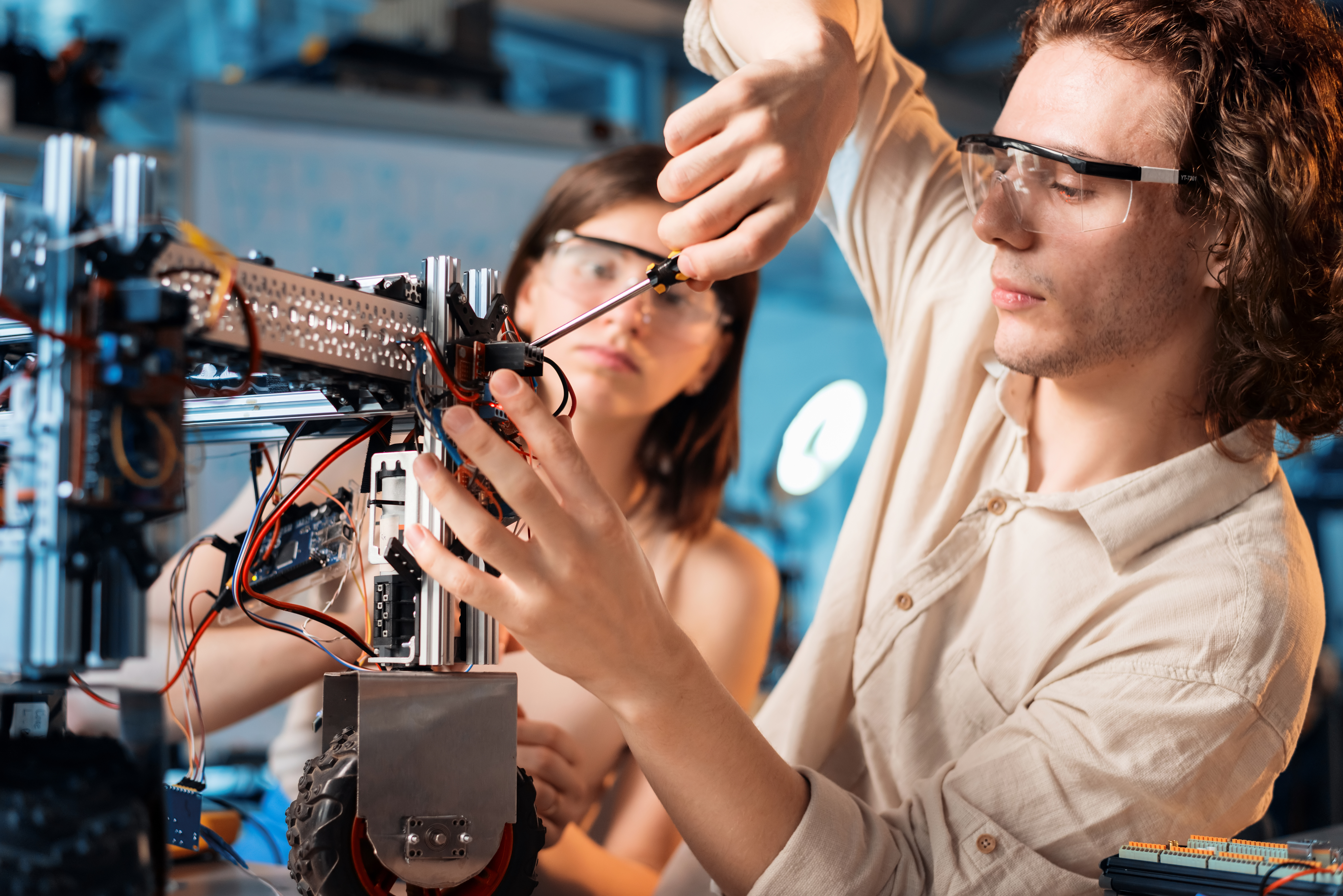 young-man-woman-protective-glasses-doing-experiments-robotics-laboratory-robot.jpg young-man-woman-protective-glasses-doing-experiments-robotics-laboratory-robot.jpg